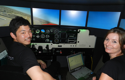 Takashi Hirose with Webster Judge Martine Dumas in the Redbird simulator