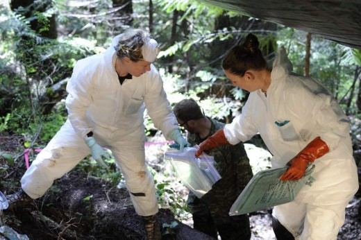 On May 5, 2014, Courtney Brown, coroner, British Columbia Coroners Service, right, and Laurel Clegg, a forensic scientist and casualty identification coordinator with the Directorate of History and Heritage in Ottawa, conduct an initial survey and recovery of the remains of four airmen from the crash of a Second World War training aircraft in British Columbia. 