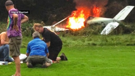 Bystanders tend the victims of a plane crash at Crawford Bay, B.C. last Saturday.