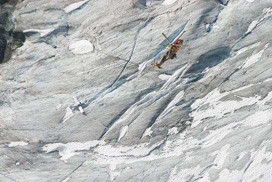 RCAF Cormorant flies over Beech Musketeer on B.C. Glacier.